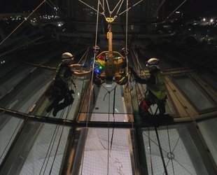 Abseilers on glass dome roof 